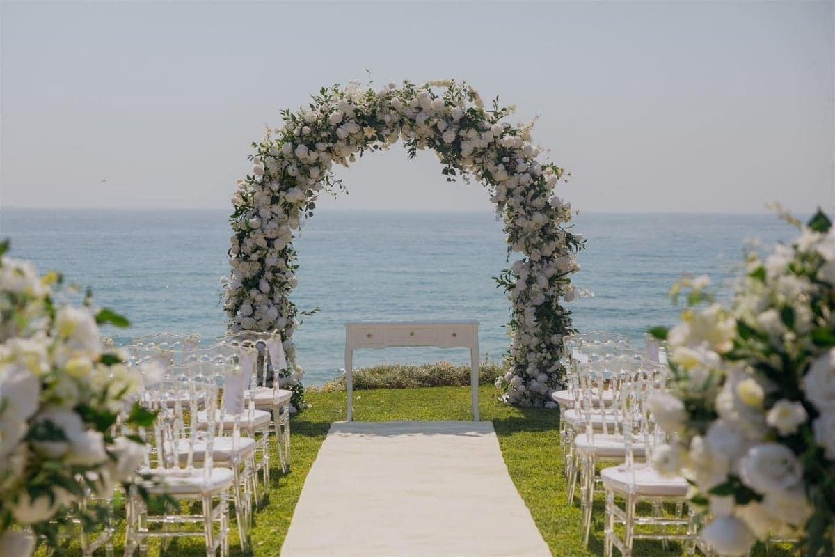 Floral ceremony arch by the sea