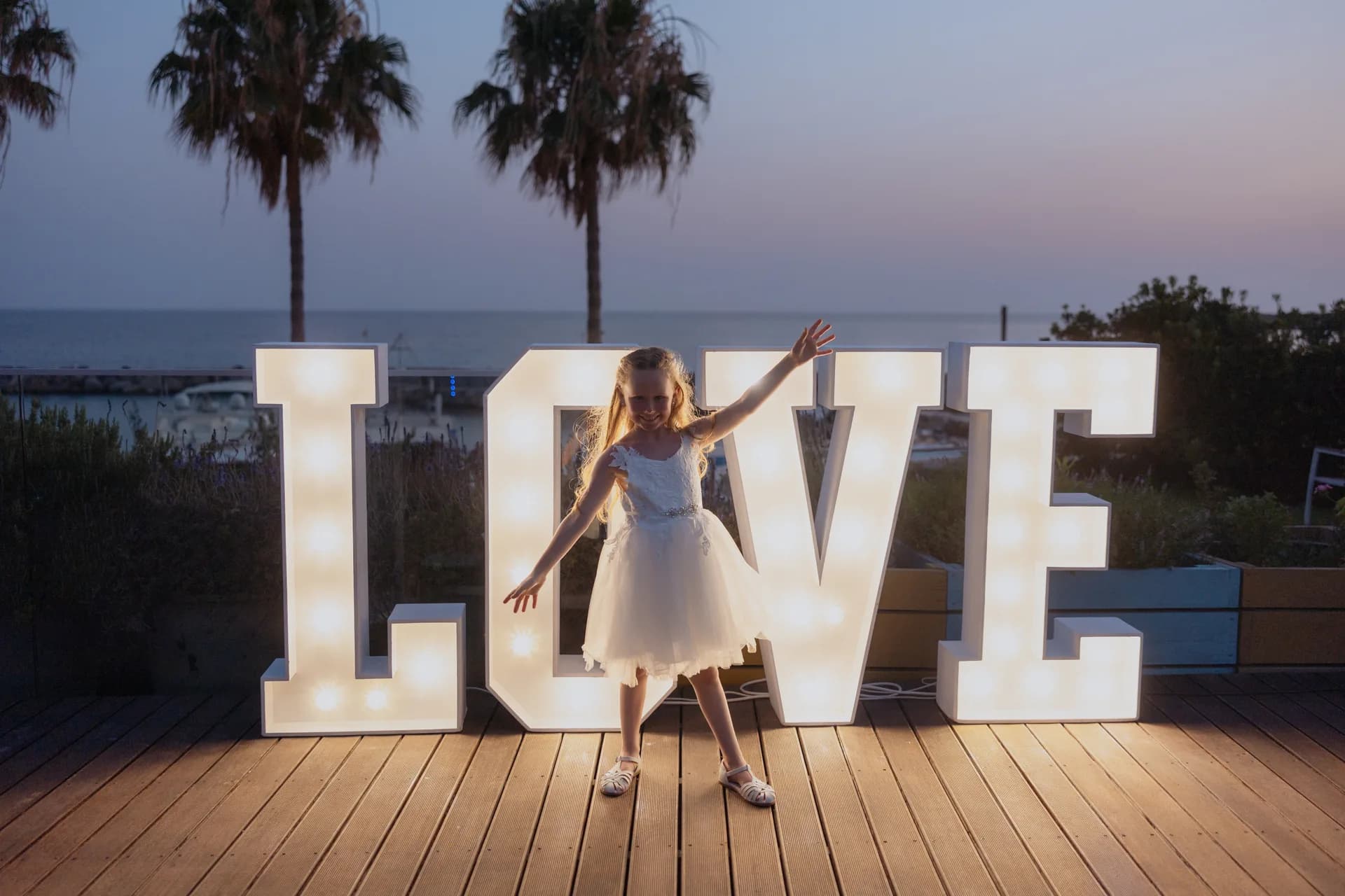 Illuminated LOVE letters on the sunset deck at Coral Beach at dusk