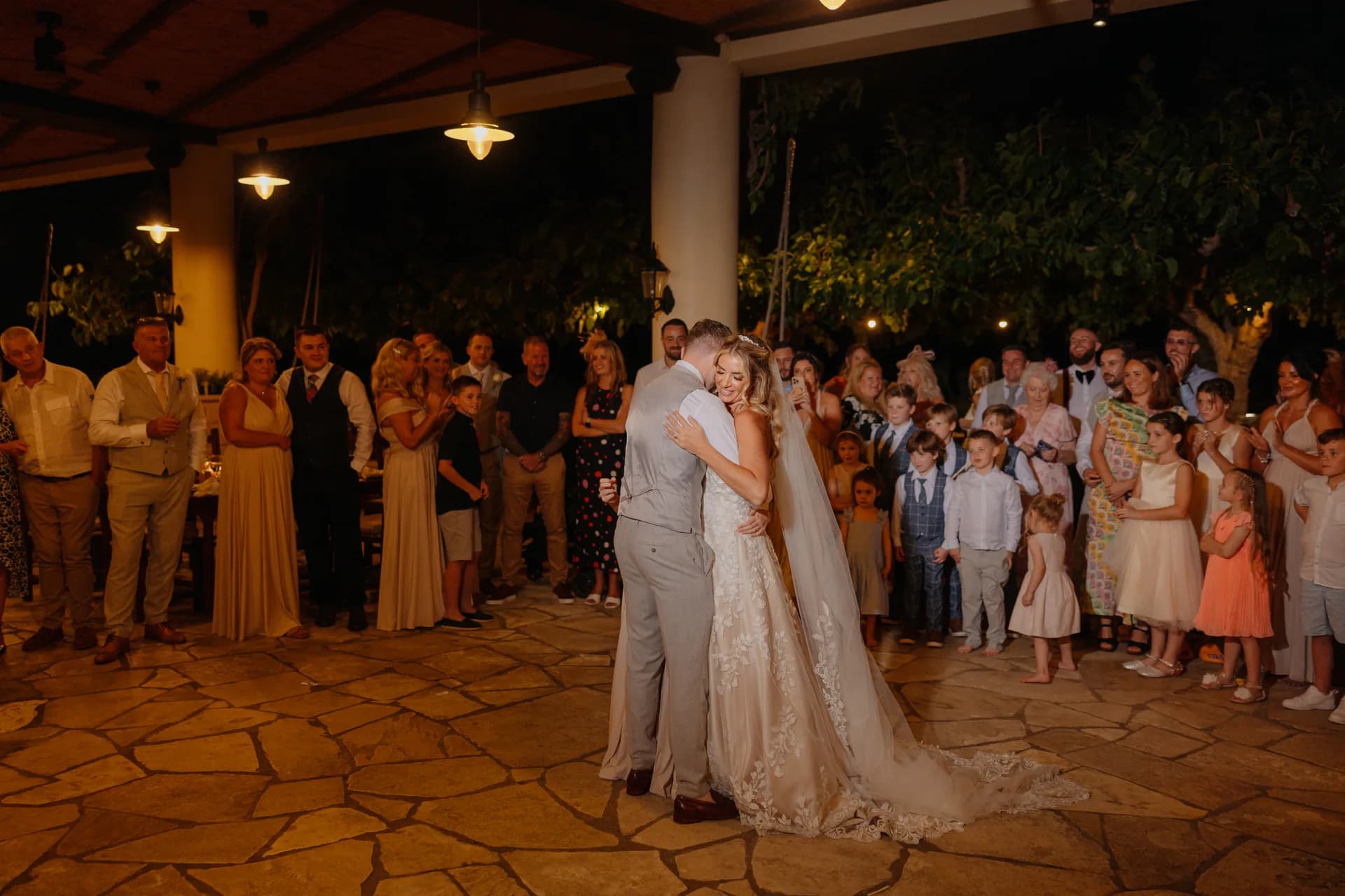 First dance on the flagstone terrace under the Elysium’s warm-lit covered pavilion