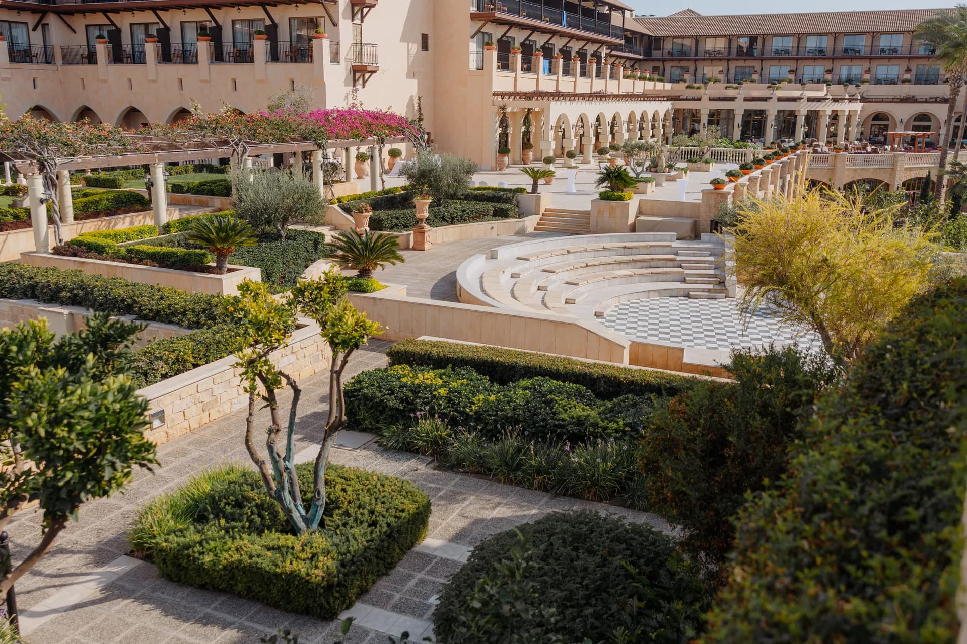 Elevated view of the Elysium’s terraced formal gardens, circular ceremony amphitheatre and long colonnaded facade