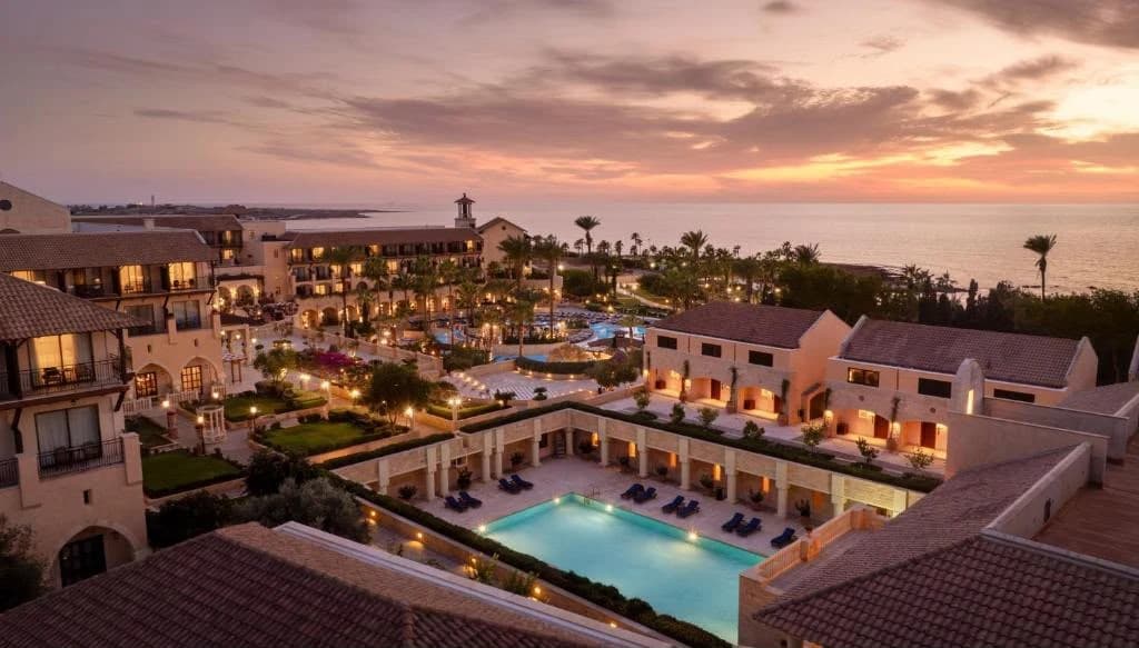 Elysium Hotel pools, gardens and Mediterranean coastline at sunset