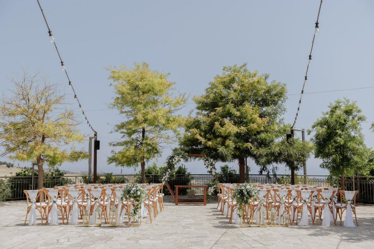 Outdoor ceremony seating at Liopetro arranged among the trees