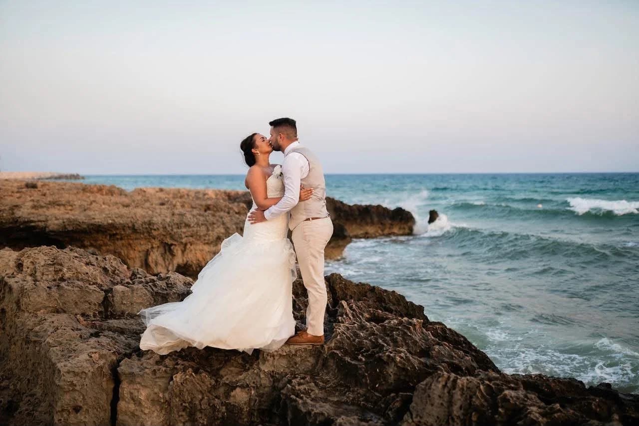 Couple on the rocky shoreline at Agia Thekla