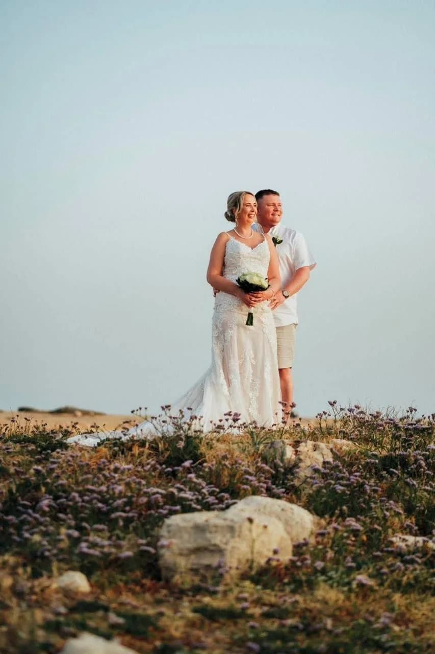 Couple on the rocky shore at Agios Georgios Beach