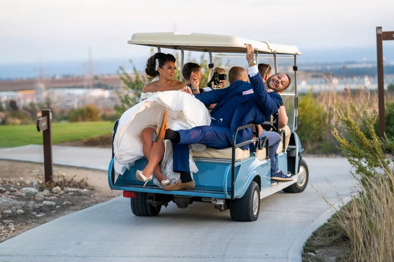 Wedding guests travelling by golf cart at Elea