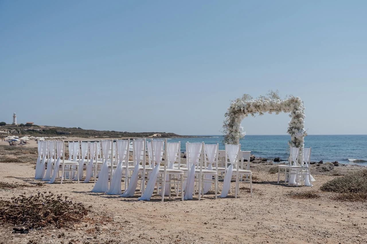 Beach ceremony chairs and arch at Faros Lighthouse Beach