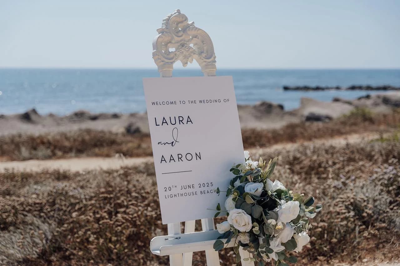 Beach ceremony welcome sign at Faros Lighthouse Beach