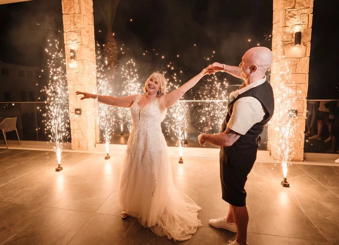 Couple dancing with sparklers inside Kefalos Beach