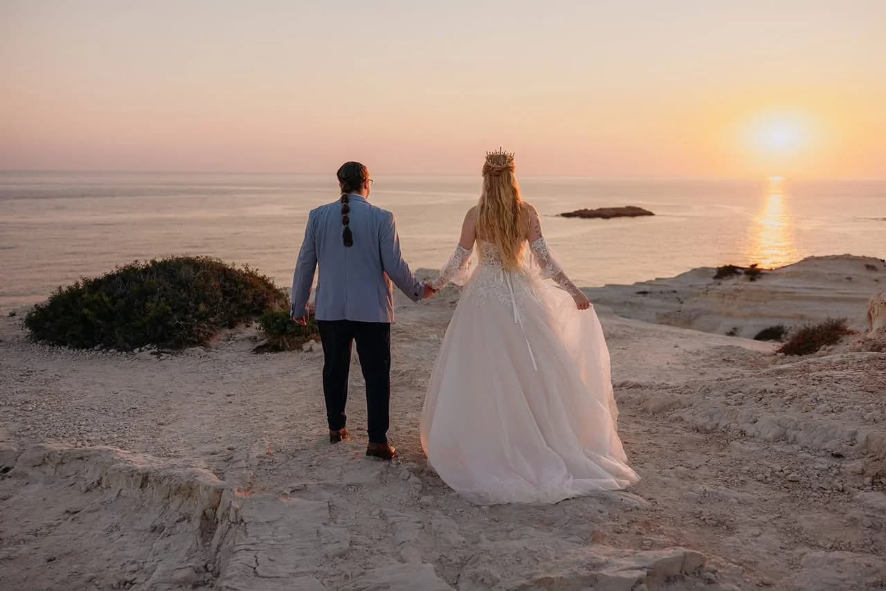 Couple by the sea after their wedding at Paliomonastiros