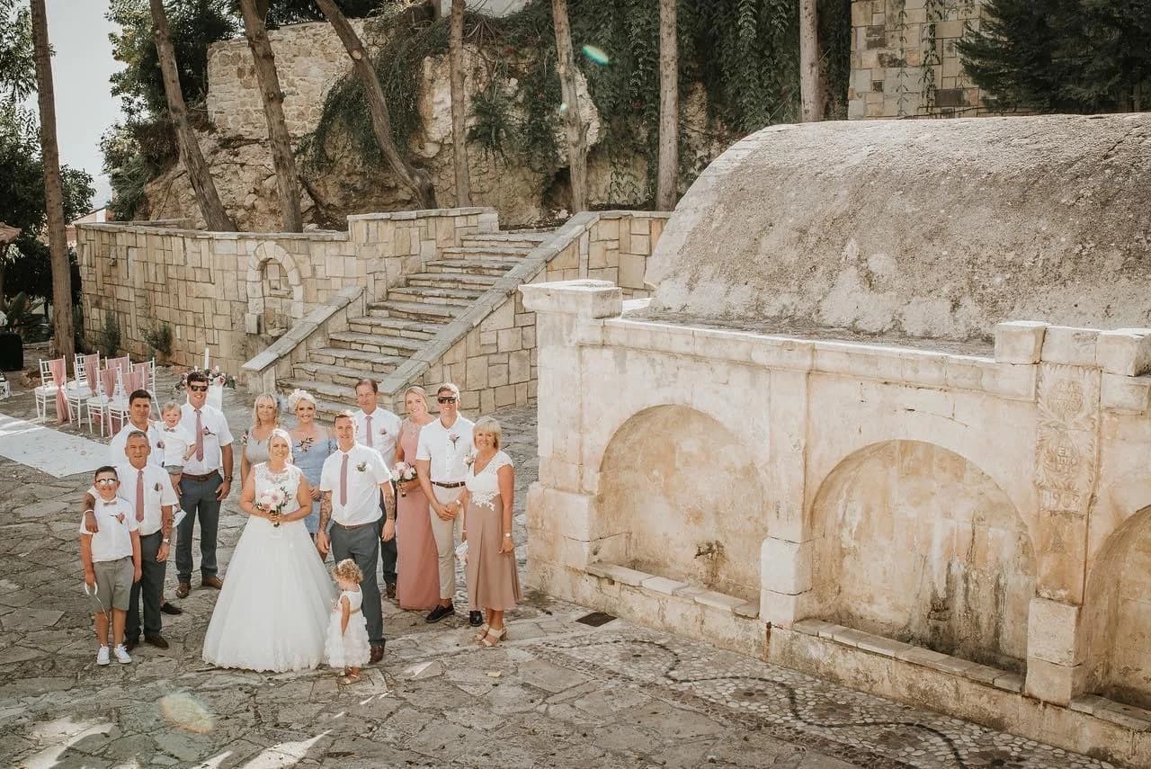 Wedding party in the stone courtyard at Pegia Gardens