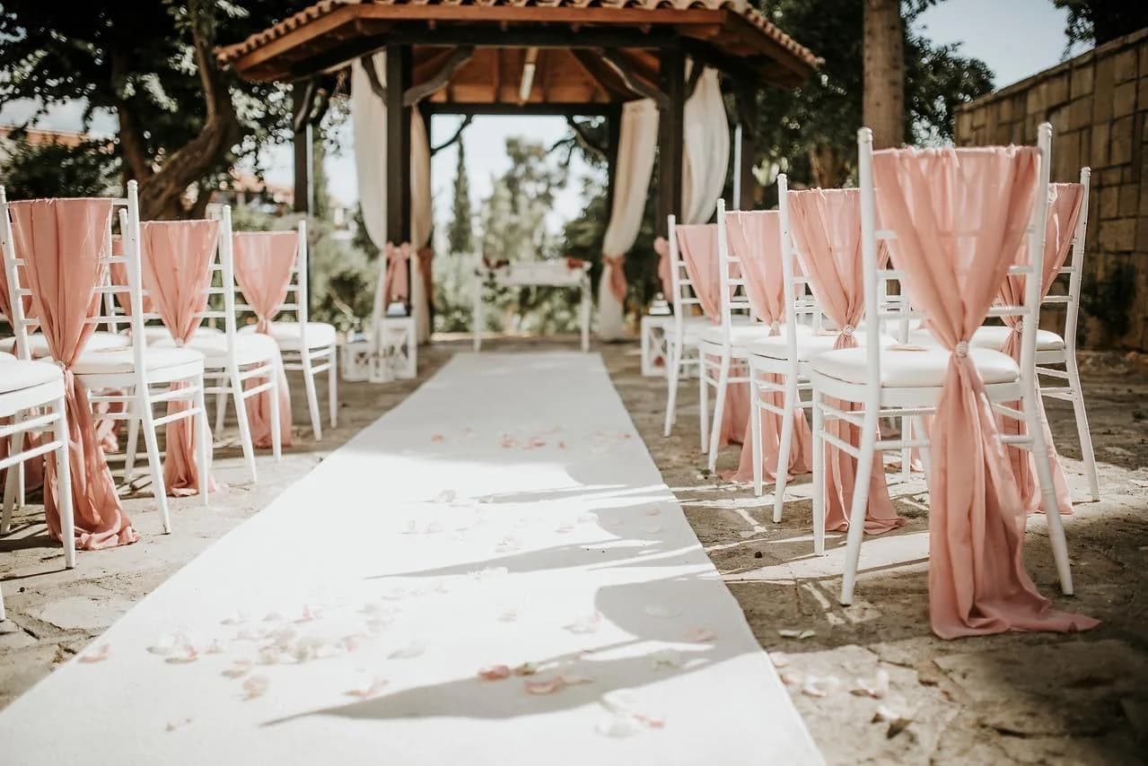 Wedding aisle beneath the pergola at Pegia Gardens