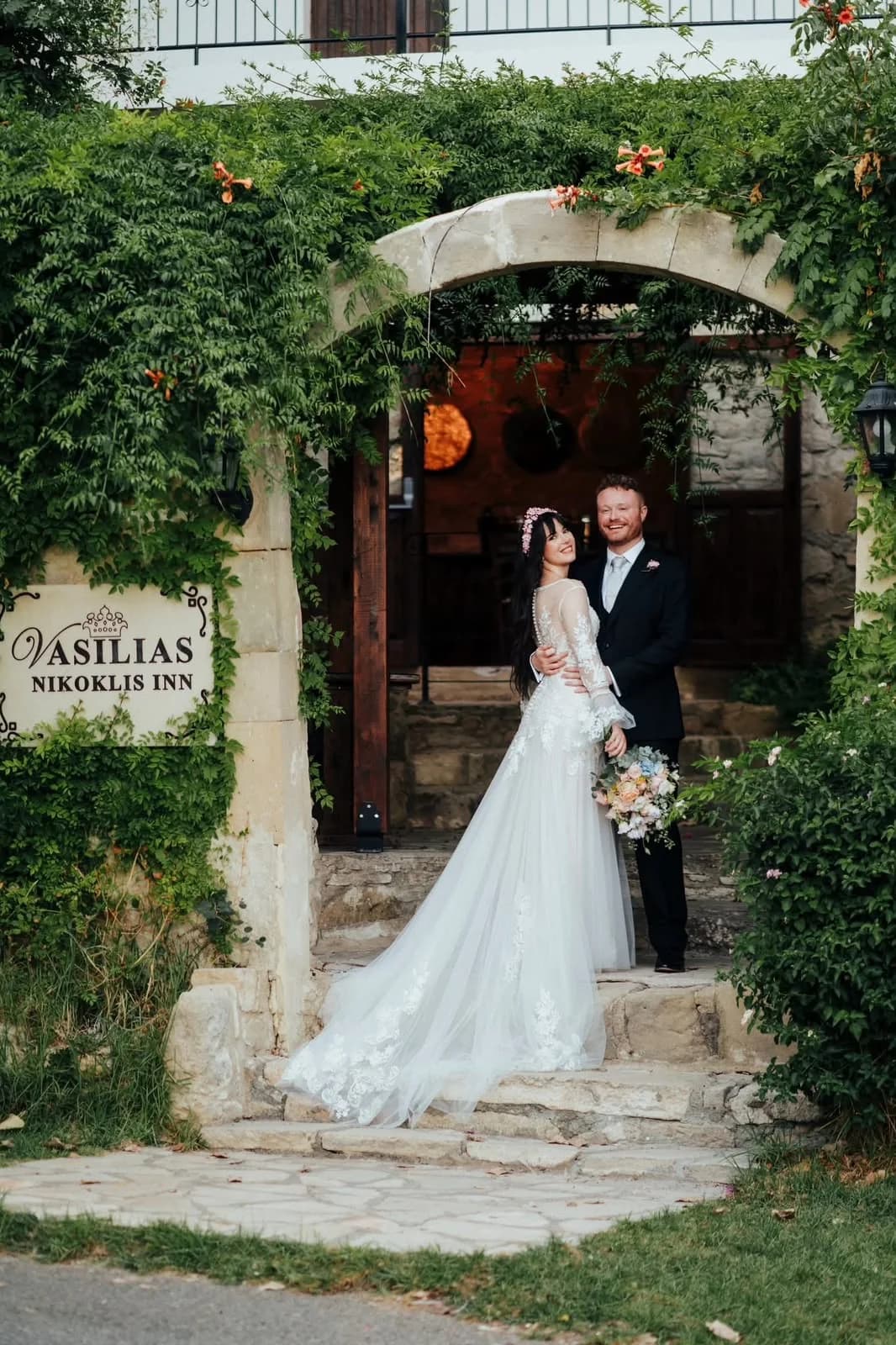 Couple at the garden entrance at Vasilias
