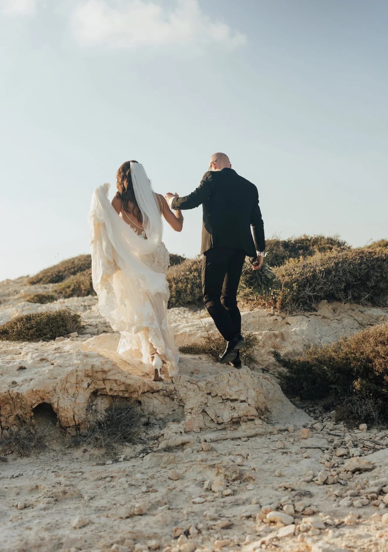 Couple walking away along a rugged coastal path