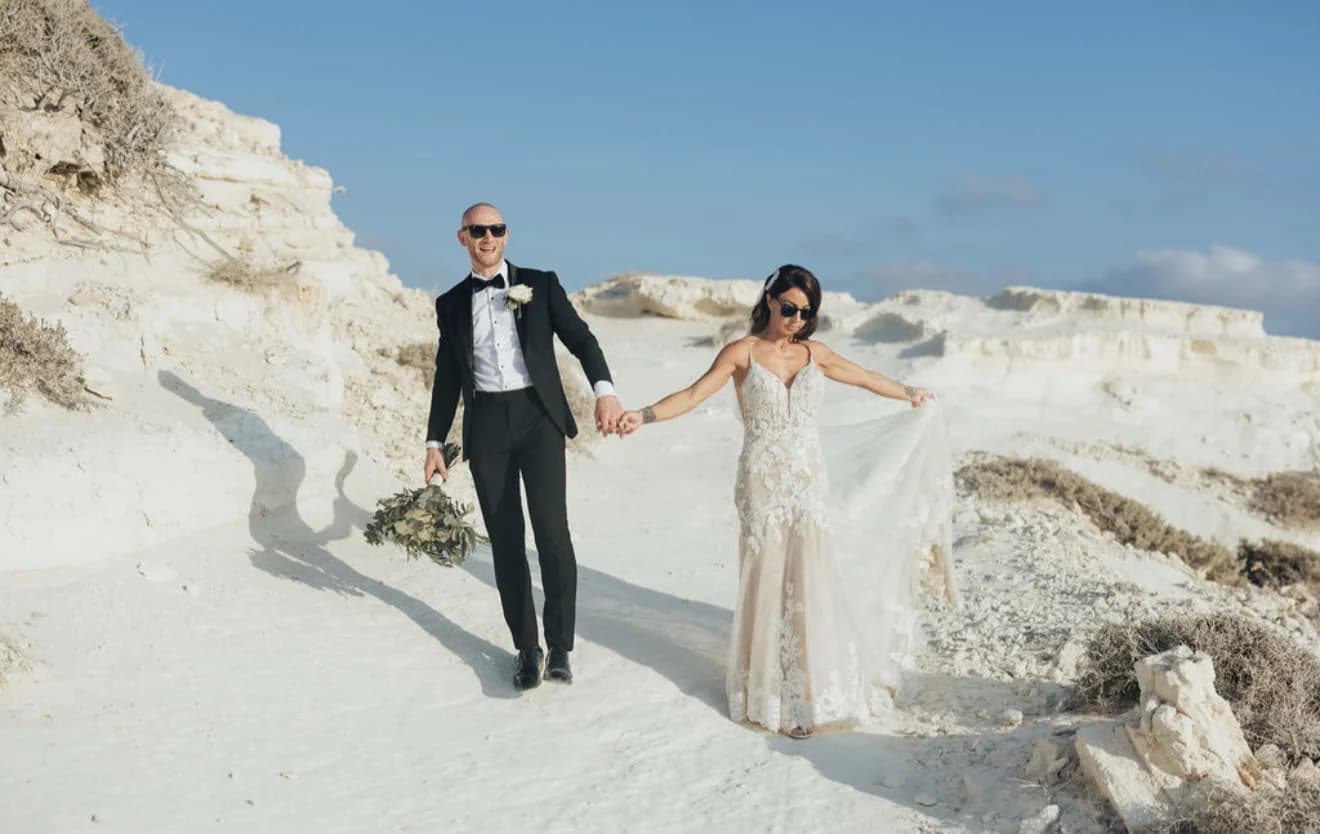 Couple walking across the white cliff landscape